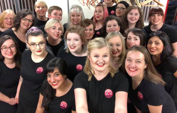 A backstage selfie of Steel City Voices in our black logo shirts